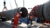 FILE - Workers are seen at the construction site of the Nord Stream 2 gas pipeline, near the town of Kingisepp, Leningrad region, Russia, June 5, 2019. 