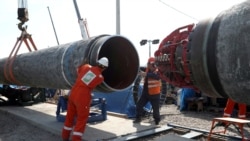 FILE - Workers are seen at the construction site of the Nord Stream 2 gas pipeline, near the town of Kingisepp, Leningrad region, Russia, June 5, 2019.