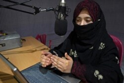 FILE - A radio presenter reads the news at the Merman station in Kandahar, Sept. 29, 2020. Once the epicenter of the Taliban’s Islamist government, Kandahar city in Afghanistan is slowly transforming into a vibrant urban center.