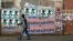 A man walks past campaign posters outside a polling center in the capital Antananarivo, Oct. 25, 2013.