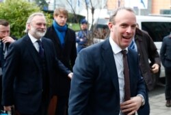 British Foreign Secretary Dominic Raab, right, arrives to meet with his Italian, German, and French counterparts, in Brussels, Belgium, Jan. 7, 2020.