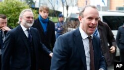 British Foreign Secretary Dominic Raab, right, arrives to meet with his Italian, German, and French counterparts, in Brussels, Belgium, Jan. 7, 2020. 