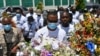 Pierre Gary Bernadotte, a member of the slain president's PHTK political party, carries flowers to a spot outside the presidential palace in memory of the late President Jovenel Moise in Port-au-Prince, Haiti, July 14, 2021.