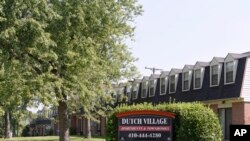FILE - A sign sits outside the Dutch Village apartments and townhomes, owned by Kushner Cos., in Baltimore, July 29, 2019. Maryland is suing the real estate company, partly owned by Jared Kushner.