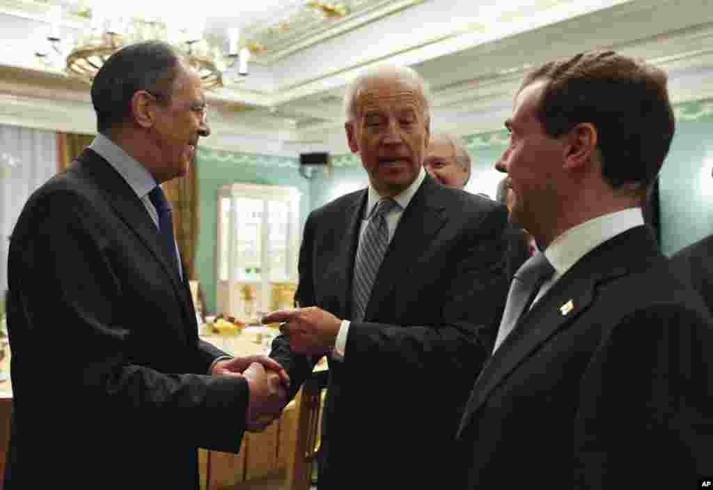 Vice President of the United States Joe Biden, center, shakes hands with Russian Foreign Minister Sergey Lavrov, left, as Russian President Dmitry Medvedev, right, looks on before talks in the Gorki presidential residence outside Moscow, Russia, Wednesday