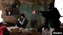 Jihadist fighters from the Jabhat al-Nusra group take up positions in Aleppo during a battle against Syrian government forces December 24,2012. Al-Nusra fighters are also accused of clashes with other anti-government rebels. 