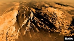 Titan is seen from the Huygens probe as it descended to the surface in 2005. 