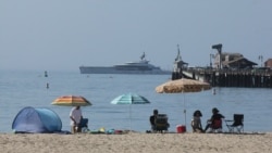 Early beachgoers secure spots on the shore at Santa Barbara, Calif., on Sunday, Aug. 16, 2020.