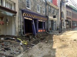 FILE - Damage along Main Street in historic Ellicott City, Maryland, is viewed Aug. 1, 2016, after the city was ravaged by floodwaters, killing two people and causing devastating damage to homes and businesses, officials said.