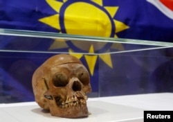 FILE — A human skull from the Herero and ethnic Nama people is displayed during a ceremony in the auditorium of Berlin's Charite hospital September 30, 2011.