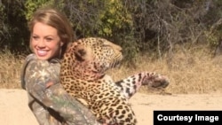 Nineteen-year old Kendall Jones poses with one of her "trophies," a near-threatened African leopard.(2014)