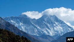 In this file photo taken on March 26, 2020, the Himalayan Mount Everest (C-L) and other mounts ranges are pictured from Namche Bazar in the Everest region, some 140 kms northeast of Kathmandu.