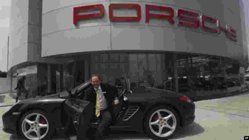 Michael Wagner, the Porsche SA brand manager for Stallion Motors Ltd. of Nigeria, sits in a new Porsche Carrera 911 outside of a showroom for the luxury brand in Lagos, Nigeria.