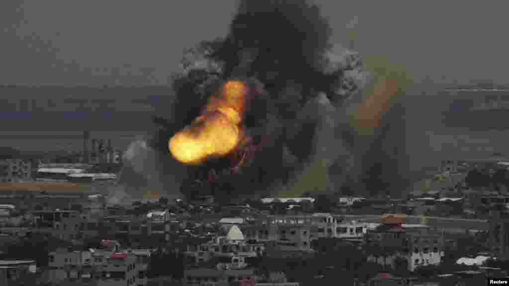 Smoke and flames are seen following what police said was an Israeli air strike in Rafah in the southern Gaza Strip July 8, 2014.