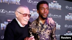 Stan Lee, left, greets cast member Chadwick Boseman at the premiere of "Black Panther" in Los Angeles, Jan. 29, 2018.