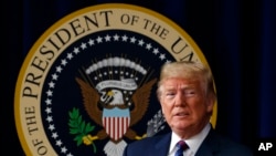 FILE - President Donald Trump arrives for a bill signing ceremony in the South Court Auditorium on the White House campus, May 30, 2018, in Washington. Trump says he has "absolute right to PARDON myself" but says has "done nothing wrong" in the Russia probe. (AP Photo/Evan Vucci)