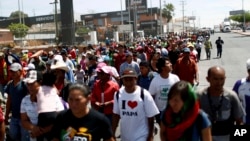 Central American migrants traveling with the annual migrant Stations of the Cross caravan march for migrants' rights and protest the policies of U.S. President Donald Trump, in Hermosillo, Mexico, April 23, 2018. 