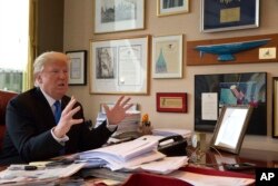 FILE - Republican presidential candidate Donald Trump gestures as he speaks during an interview with The Associated Press in his office at Trump Tower in New York, May 10, 2016. Trump once hired a man convicted of trying to break a triple murderer out of prison to oversee residential operations inside Trump Tower. The man was later accused by former workers of perpetuating a cash-for-jobs scheme.