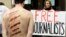 Reporters Without Borders activists, with mock injuries, demonstrate outside the Iran Air office on the Champs Elysées in Paris, July 10, 2012.