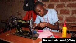 Girls at the Parents Care Infant Academy, including 14-year-old Catherine Nantume, are sewing a reusable sanitary towel in Makindye Kampala.
