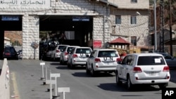 FILE - A convoy of inspectors from the Organization for the Prohibition of Chemical Weapons prepares cross into Syria at the Lebanese border crossing point of Masnaa, Oct. 1, 2013.