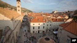 Crowds of tourists clog the entrances into the ancient walled city of Dubrovnik, a UNESCO World Heritage Site in Croatia, as huge cruise ships unload thousands more daily, Sept. 7, 2018