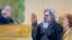 This artist's rendering shows United States Magistrate, Judge John Facciola, swearing in the defendant, Libyan militant Ahmed Abu Khatallah, wearing a headphone, as his attorney Michelle Peterson looks on during a hearing at the federal U.S. District Cour