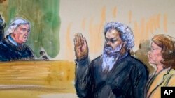 This artist's rendering shows United States Magistrate, Judge John Facciola, swearing in the defendant, Libyan militant Ahmed Abu Khatallah, wearing a headphone, as his attorney Michelle Peterson looks on during a hearing at the federal U.S. District Cour