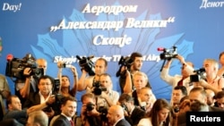 FILE - Members of the media take pictures of the former Macedonian Prime Minister Nikola Gruevski during the opening ceremony of the airport Alexander the Great in Skopje, Macedonia, June 9, 2011. 