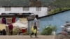 FILE - A man carries containers filled with gasoline to sell on the streets in Cap-Haitien, Haiti, April 29, 2024. 