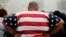 In this May 8, 2014 photo, an overweight man wears a shirt patterned after the American flag during a visit to the World Trade Center, in New York. 