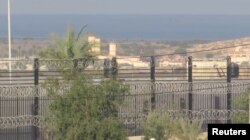 FILE - A border wall topped with concertina wire, near Rafah border, Egypt, December 16, 2023 is seen in this screen grab taken from a handout video.