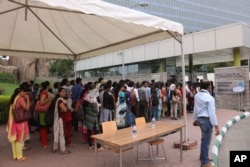 Employees queue up for security check before entering Waverock Apple development office in Hyderabad, India, May 19, 2016. Apple will set up an app design and development center in southern India, the company announced.