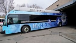Kevin Baker, a maintenance technician, drives a hydrogen fuel cell bus out of the terminal, Tuesday, March 16, 2021, in Canton, Ohio. (AP Photo/Tony Dejak)