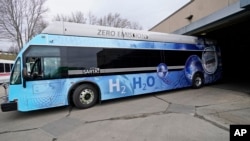 Kevin Baker, a maintenance technician, drives a hydrogen fuel cell bus out of the terminal, Tuesday, March 16, 2021, in Canton, Ohio. (AP Photo/Tony Dejak)