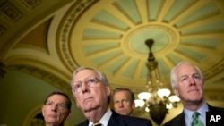 FILE - Senate Majority Leader Mitch McConnell of Ky., with from left, Sen. John Barrasso, R-Wyo., Sen. John Thune, R-S.D., and Senate Majority Whip John Cornyn of Texas, attend a news conference on Capitol Hill in Washington, June 21, 2016.