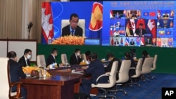 FILE - In this photo provided by the An Khoun Sam Aun/National Television of Cambodia, Cambodian Prime Minister, at upper left, joins an online meeting of the ASEAN-China special summit at Peace Palace in Phnom Penh, Cambodia, Nov. 22, 2021.