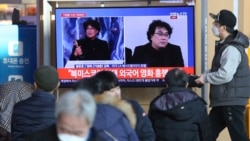 People watch a TV screen showing images of South Korean director Bong Joon Ho during a news program at the Seoul Railway Station in Seoul, South Korea, Monday, Feb. 10, 2020.