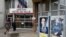 Posters of presidential election candidates Emmanuel Macron and Marine Le Pen are seen outside a polling station during the second round of 2017 French presidential election in Vaulx-en-Velin, France, May 7, 2017. 