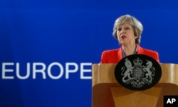 FILE - British Prime Minister Theresa May answers a question from the media.