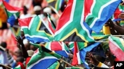 South African football fans wave national flags at one of their team's World Cup warm-up games.....National pride is evident all over the host country in the build-up to the soccer showpiece