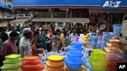 In this Nov. 26, 2011 photo, Indians shop at a crowded market in Mumbai, India. The arrival of modern retailing would hasten a cultural transformation in the way Indians shop and work.