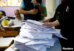 Lebanese election officials count ballots after the polling station closed during Lebanon's parliamentary election, in Beirut, Lebanon, May 6, 2018.