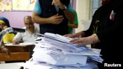 Lebanese election officials count ballots after the polling station closed during Lebanon's parliamentary election, in Beirut, Lebanon, May 6, 2018. 