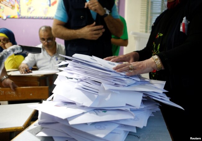 Lebanese election officials count ballots after the polling station closed during Lebanon's parliamentary election, in Beirut, Lebanon, May 6, 2018.