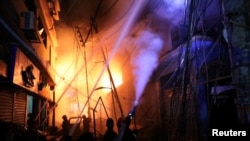 Firefighters work at the scene of a fire that broke out Feb. 20, 2019, at a chemical warehouse in Dhaka, Bangladesh. 