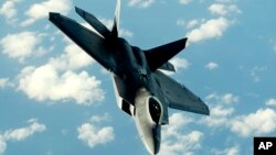 FILE - This U.S. Air Force photo shows an F-22A Raptor returning to a mission after receiving fuel from a KC-135T Stratotanker aircraft Jan. 23, 2009, at Kadena Air Base in Japan. 