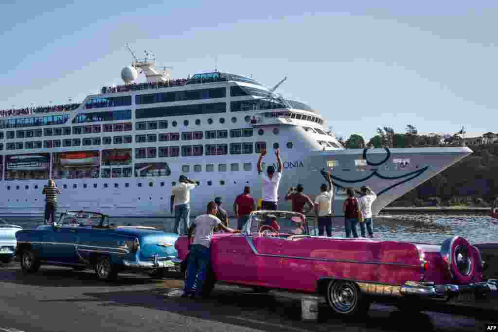 Cubans watch as the first U.S.-to-Cuba cruise ship glides into the port of Havana.