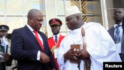 Ghana's President John Dramani Mahama (L) speaks with Gambia's President Yahya Jammeh (R) after a West African regional bloc ECOWAS summit on the crisis in Mali and Guinea Bissau, in Yamoussoukro, Ivory Coast, February 27, 2013.