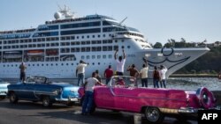 Cubans watch as the first US-to-Cuba cruise ship to arrive in the island nation in decades glides into the port of Havana, on May 2, 2016. 